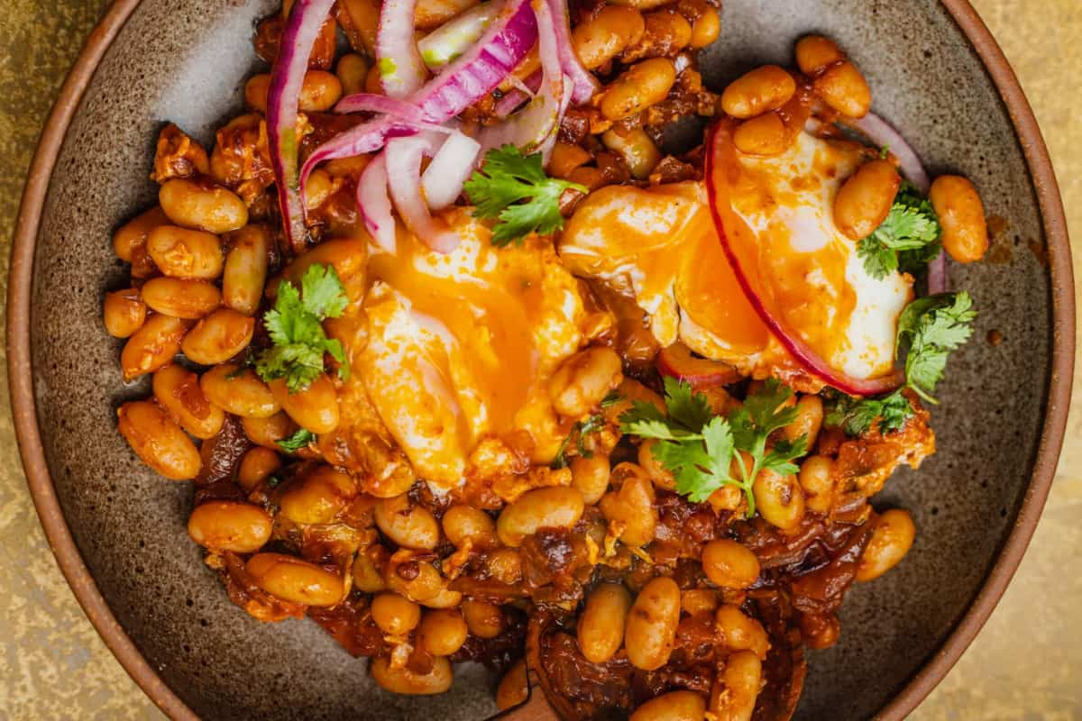 A bowl of high protein beans and eggs.