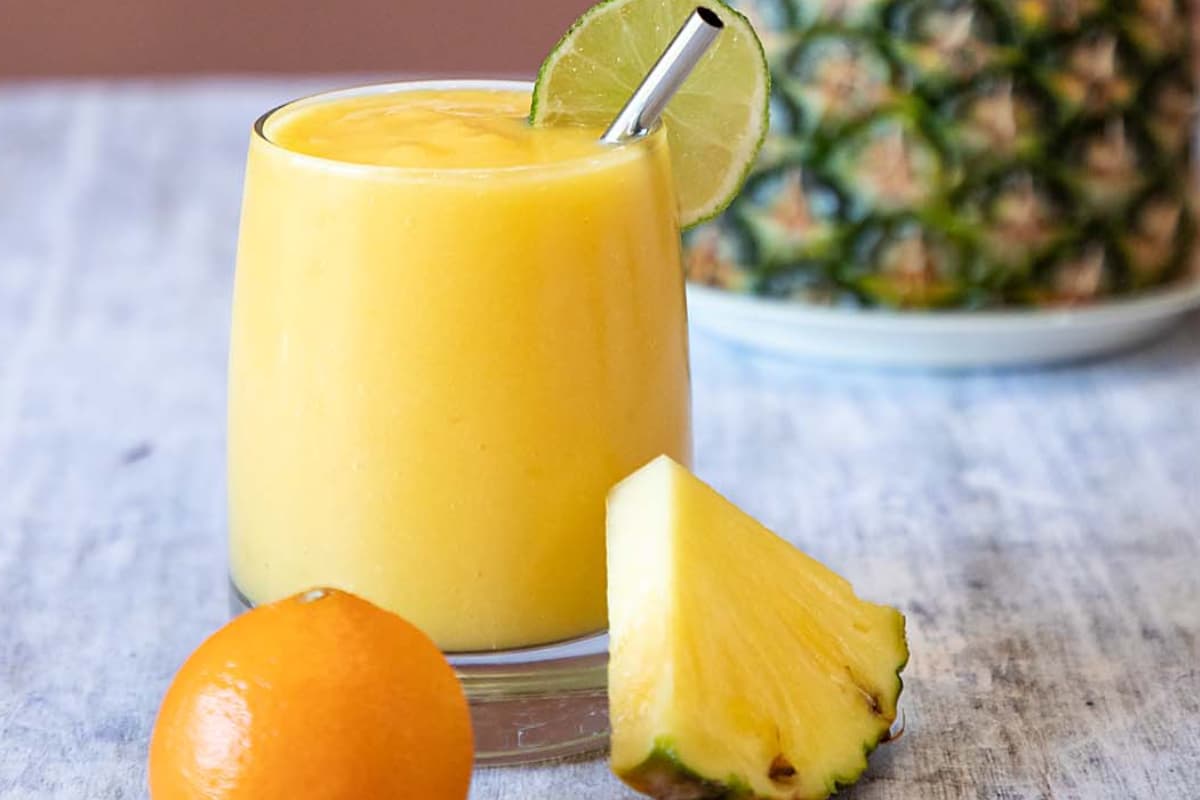 Mango pineapple smoothie in a glass.