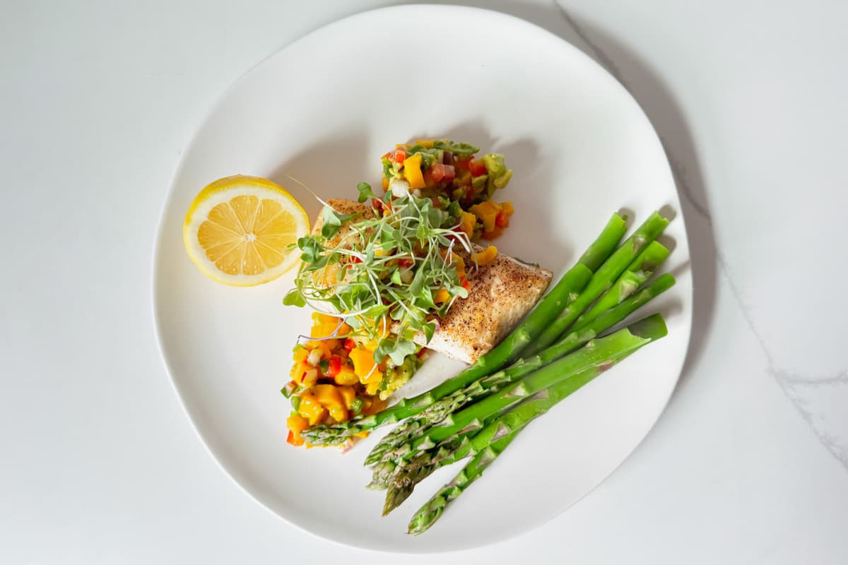 A plate of pan seared halibut.