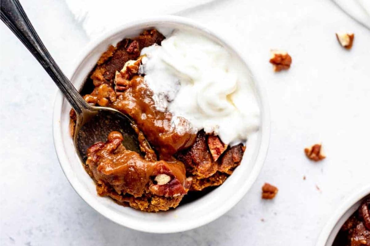 A bowl of pumpkin cake with applesauce.