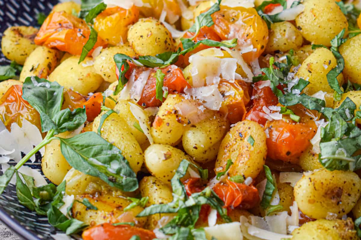 A dish of sheet pan tomatoes and gnocchi.