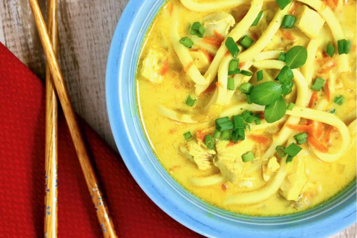 A bowl of spicy mulligatawny chicken noodle soup.