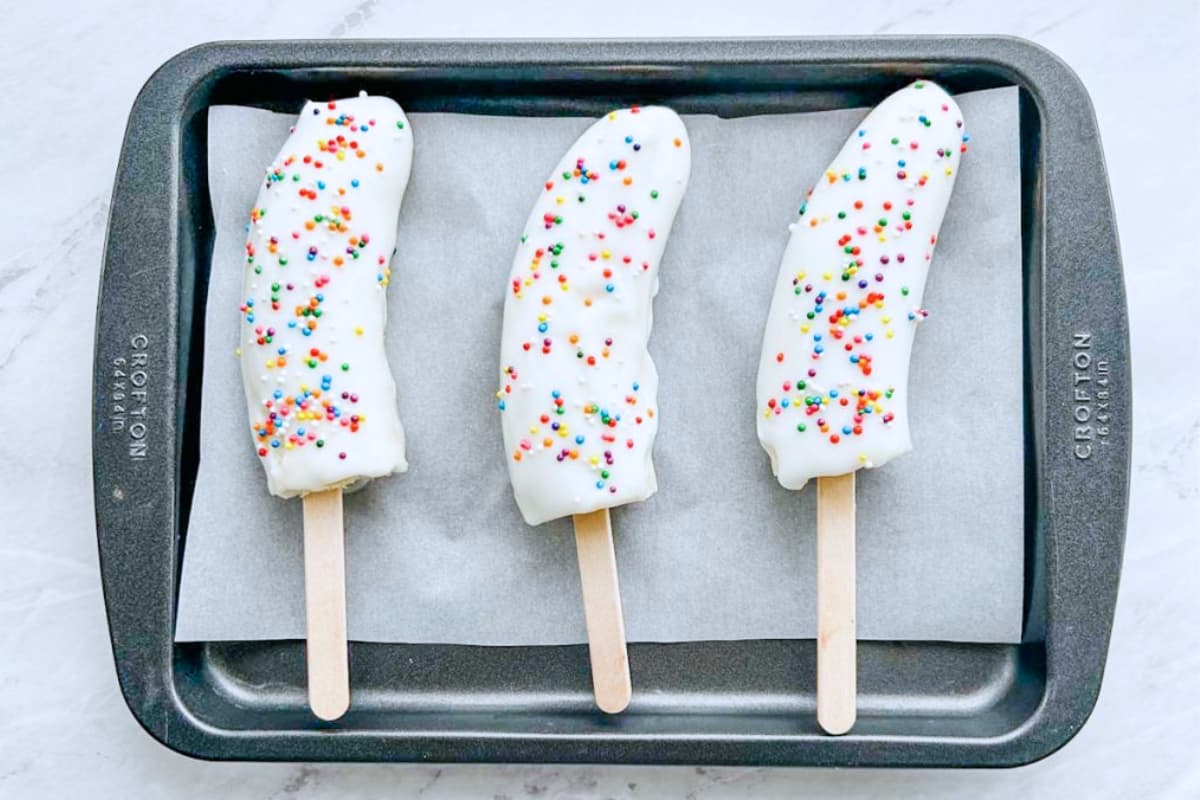 A tray of banana pops.