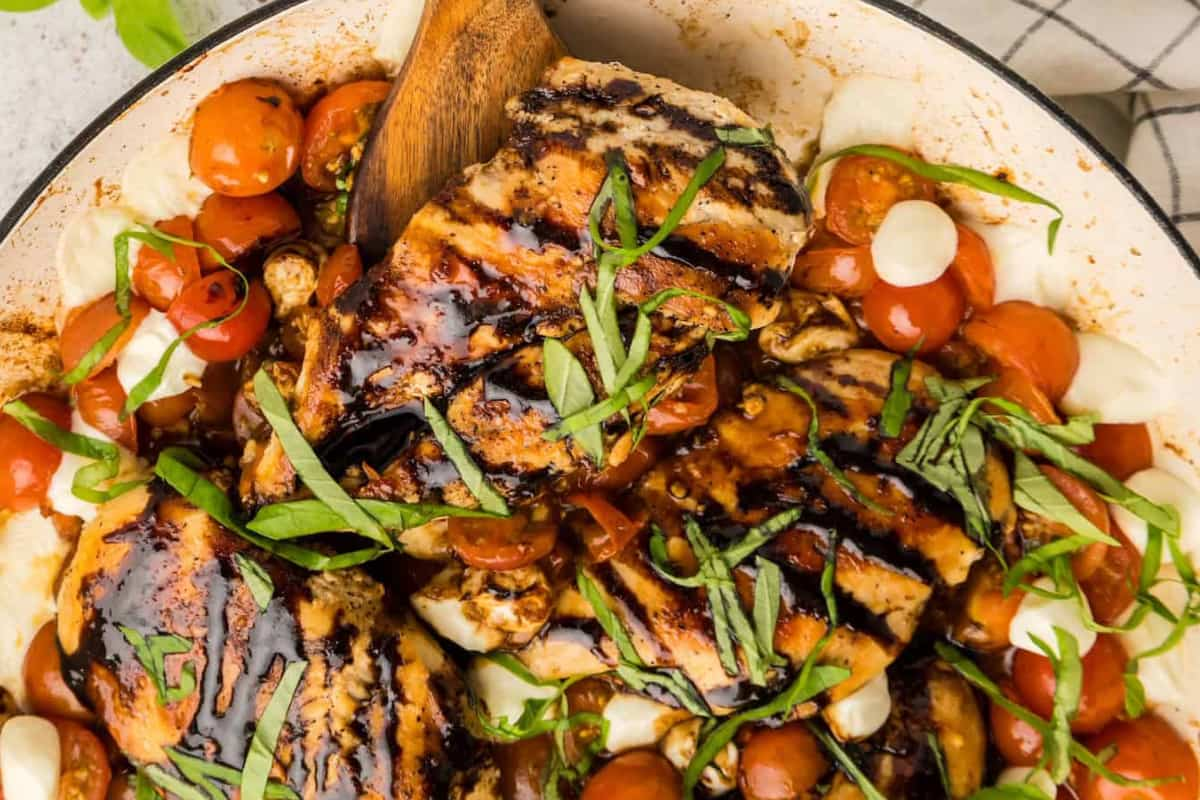 A skillet of caprese chicken.