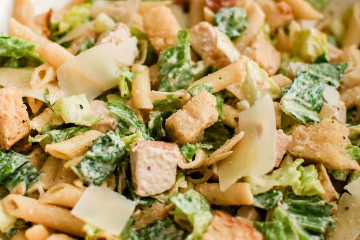 A bowl of chicken caesar pasta salad.