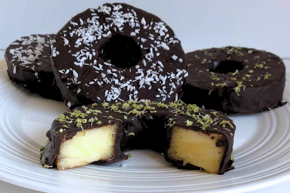 A plate of chocolate covered pineapple.