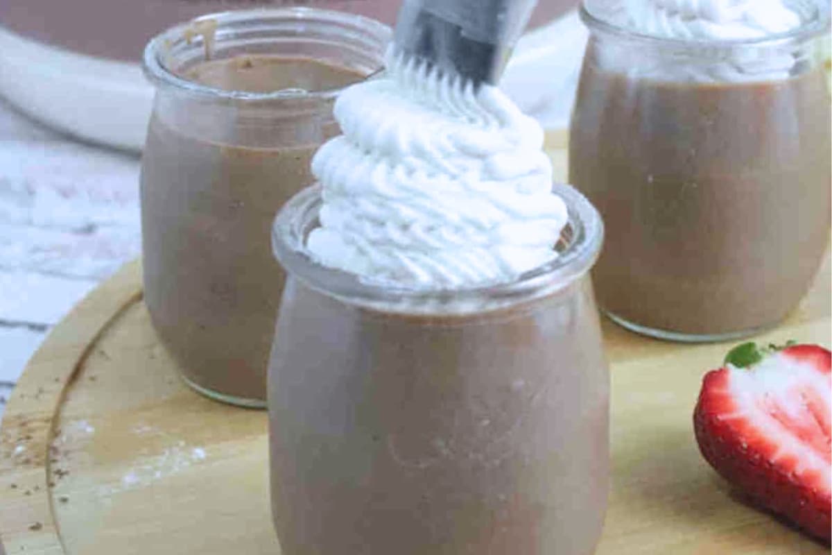 A glass jar of chocolate protein mousse.