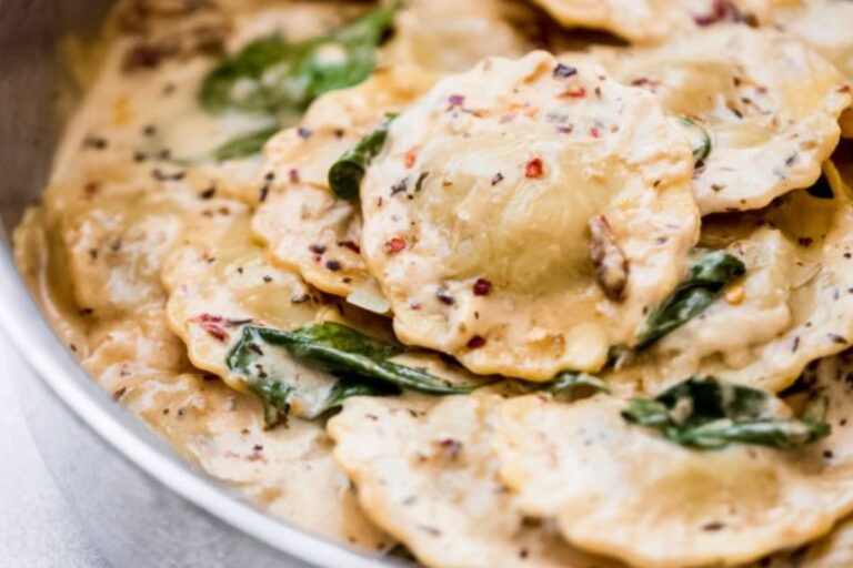 A dish of creamy tuscan ravioli.