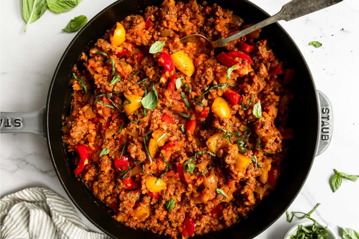 Overhead image of a deconstructed stuffed peppers in a skillet.