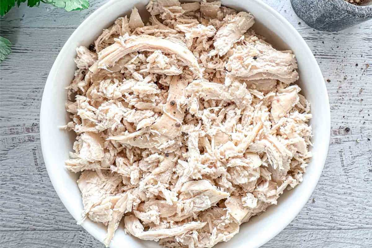 A bowl of dutch oven shredded chicken.