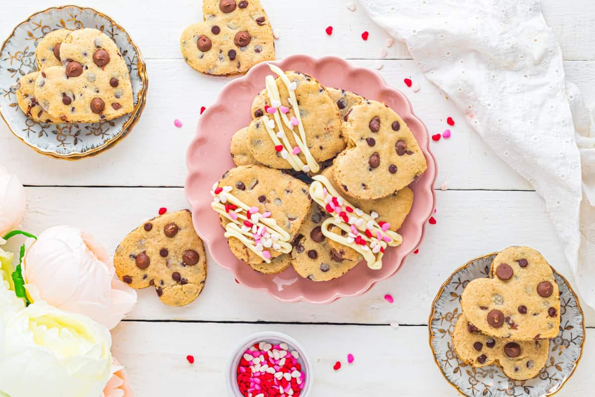 A plate of heart-shaped chocolate chip cookies.