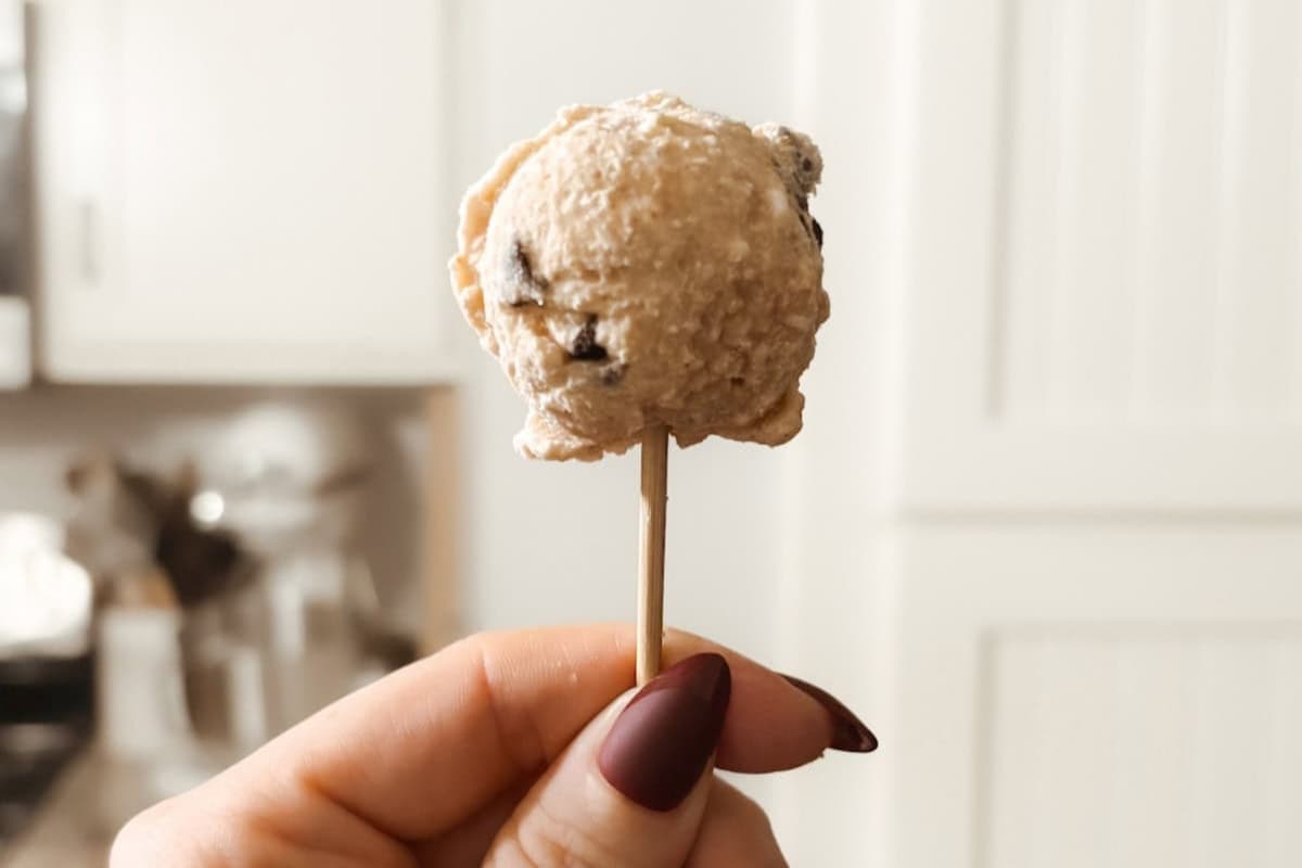 A hand holding a homemade yogurt pop.