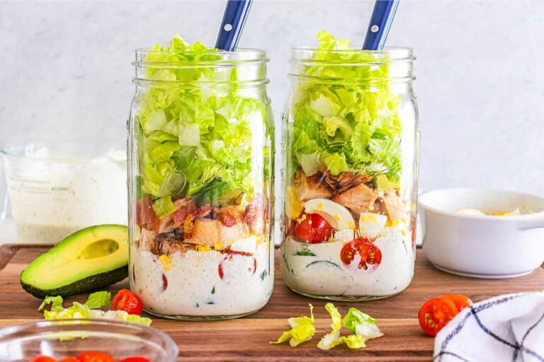 Mason jar salads on a counter.