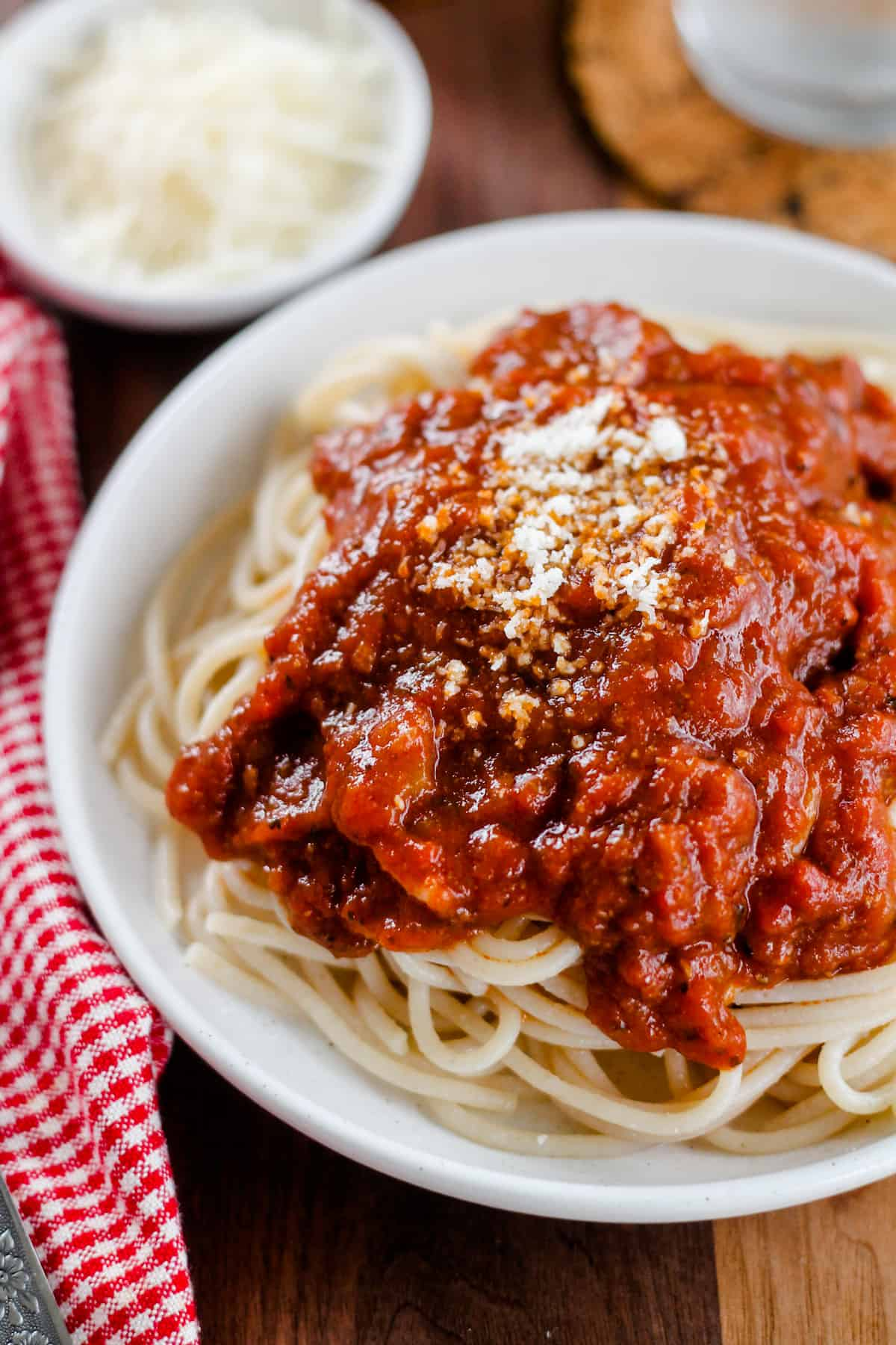 A plate of pasta with rich tomato sauce.