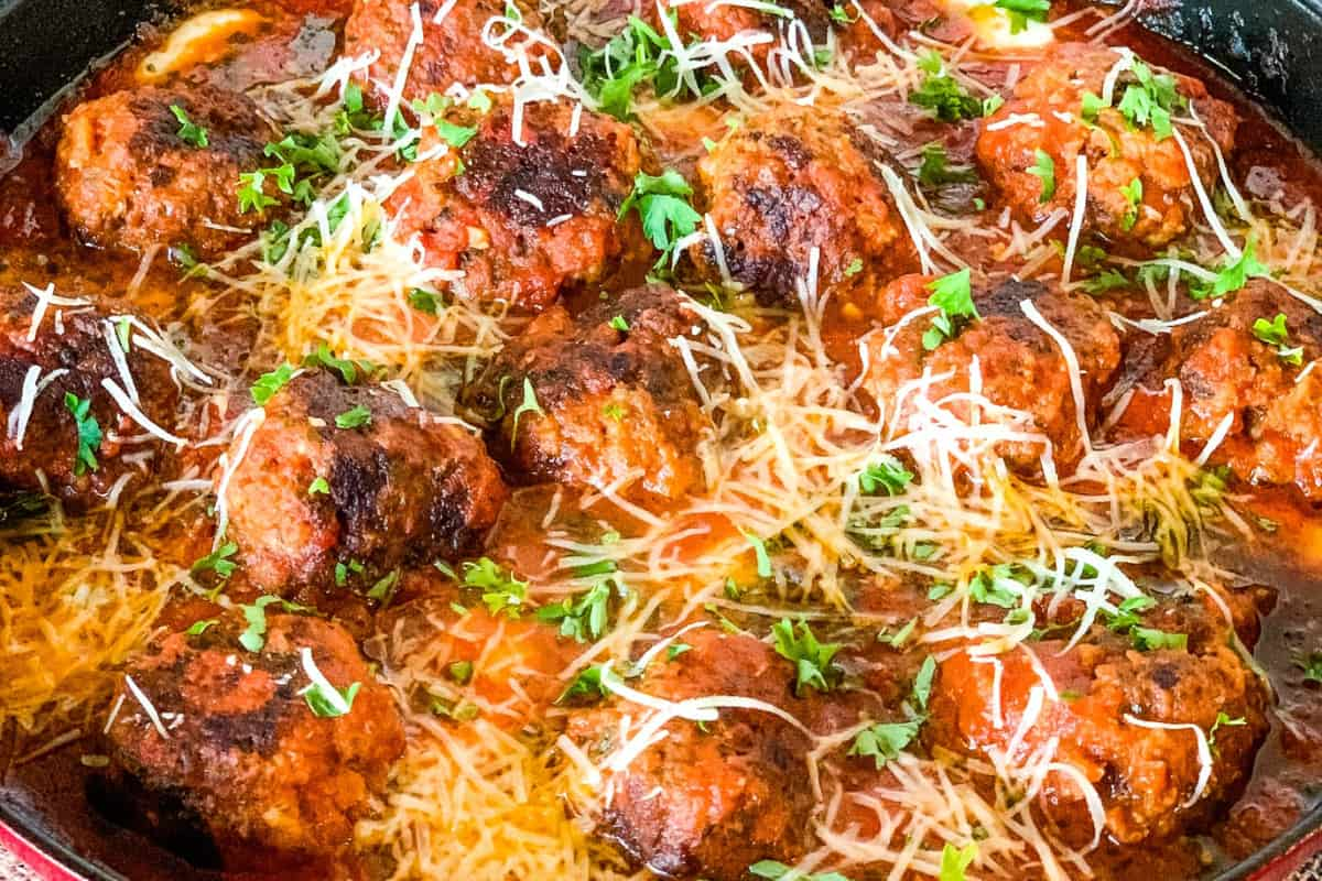 Close up image of skillet meatball marinara.