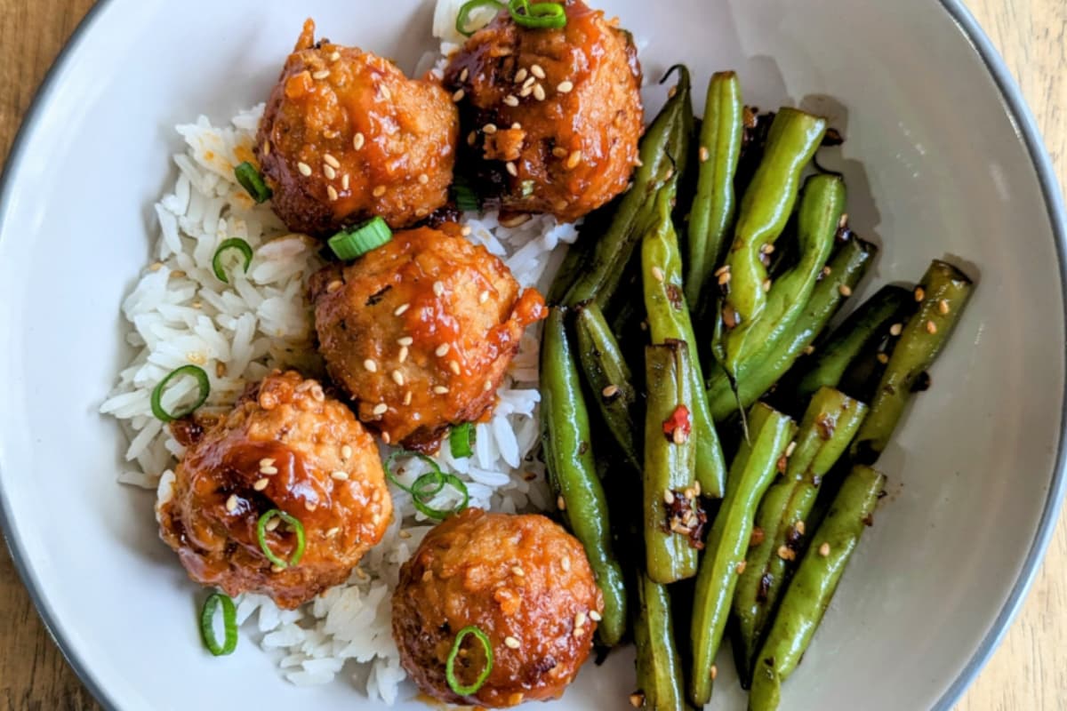 A bowl of spicy korean meatballs.