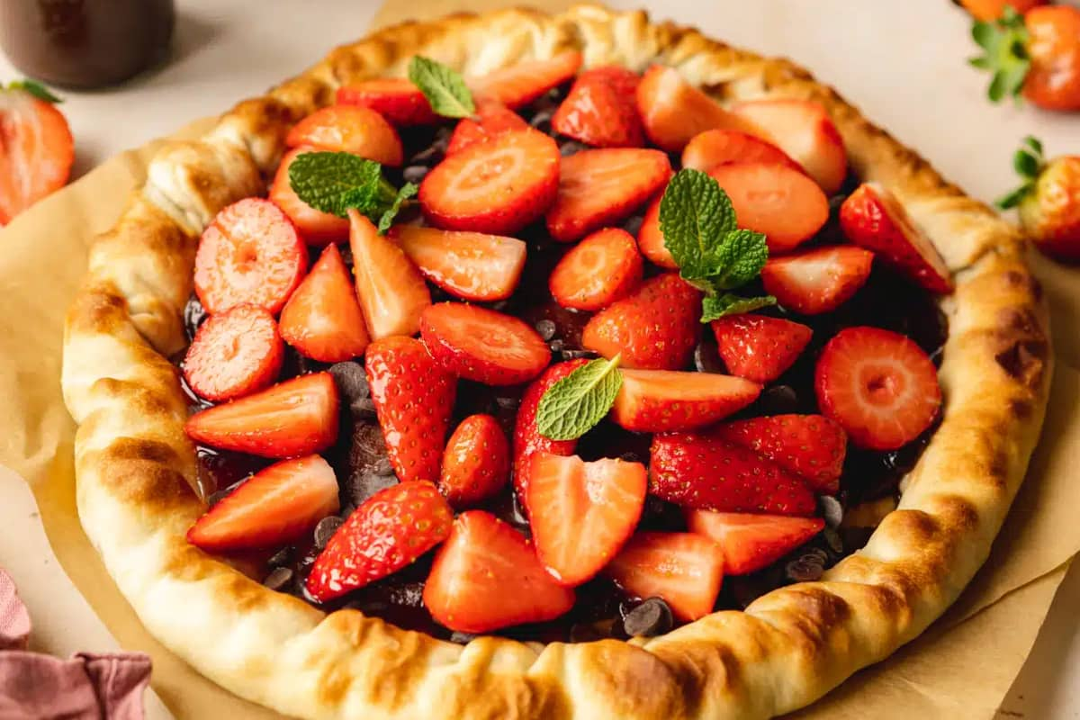 A plate of strawberry chocolate pizza.