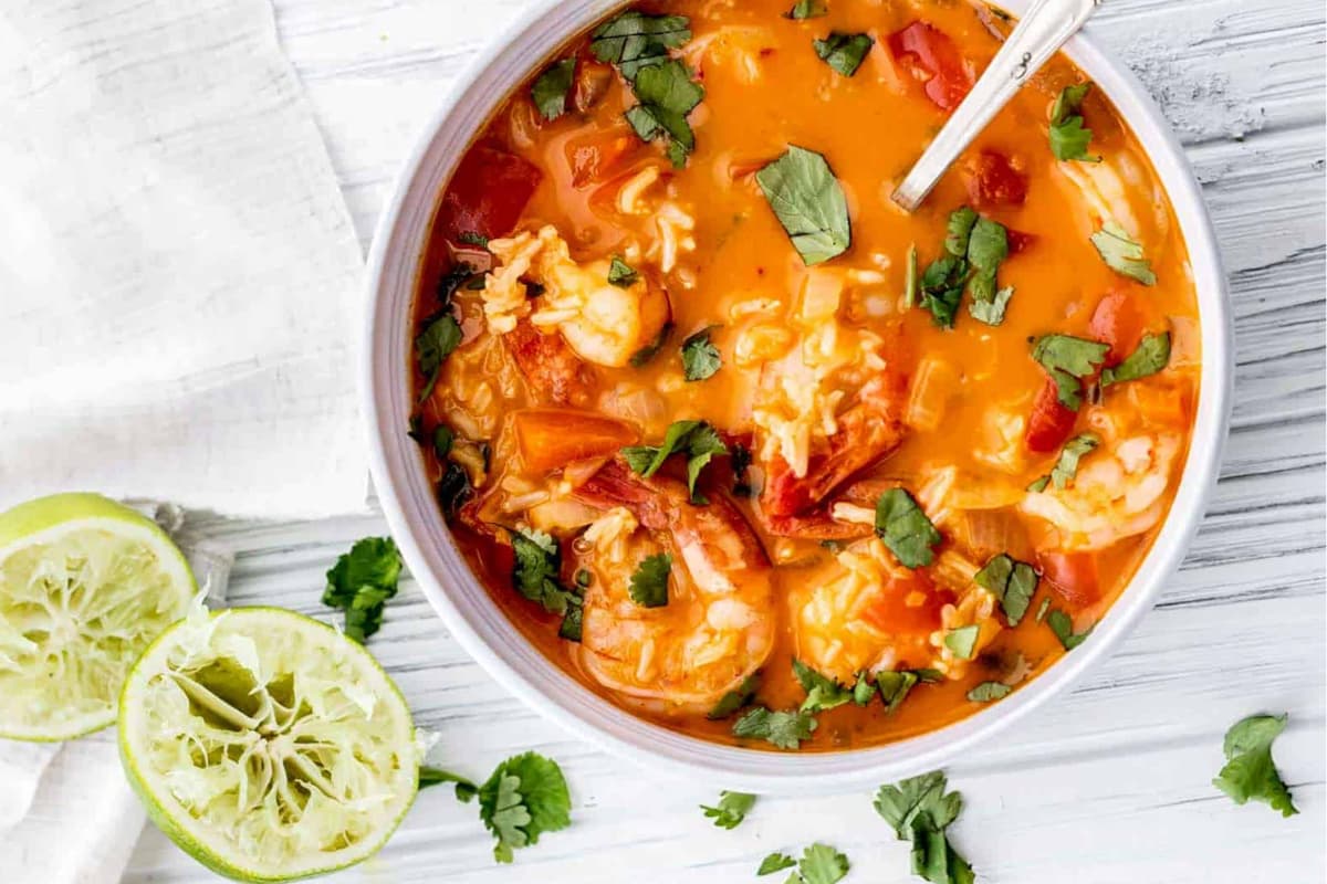 A bowl of thai shrimp coconut curry soup.