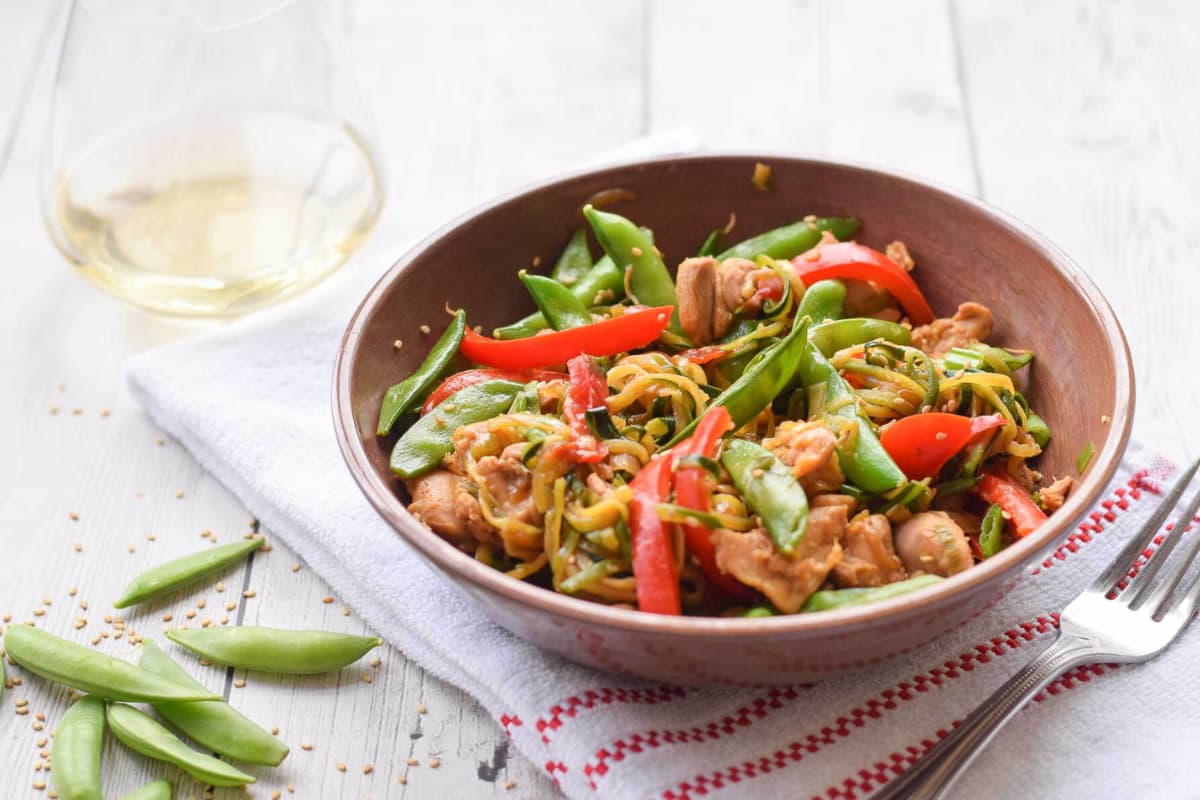 A bowl of zucchini noodle stir fry.