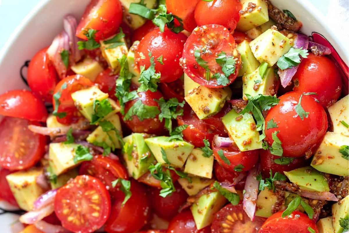 Overhead image of a avocado tomato salad with chia seed dressing.