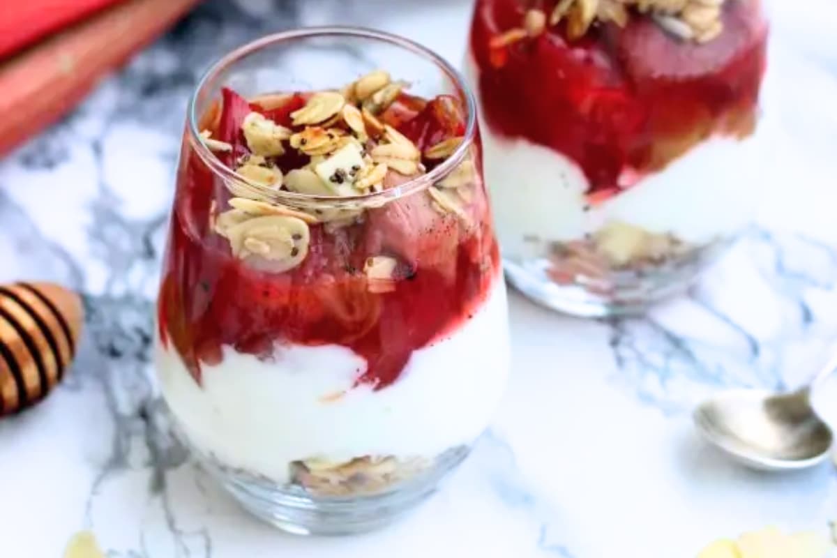 Two greek yogurt cheesecake in a jars on a counter.