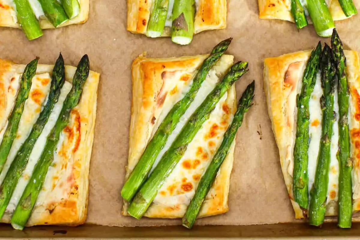 A plate of Cheesy Asparagus Tarts.