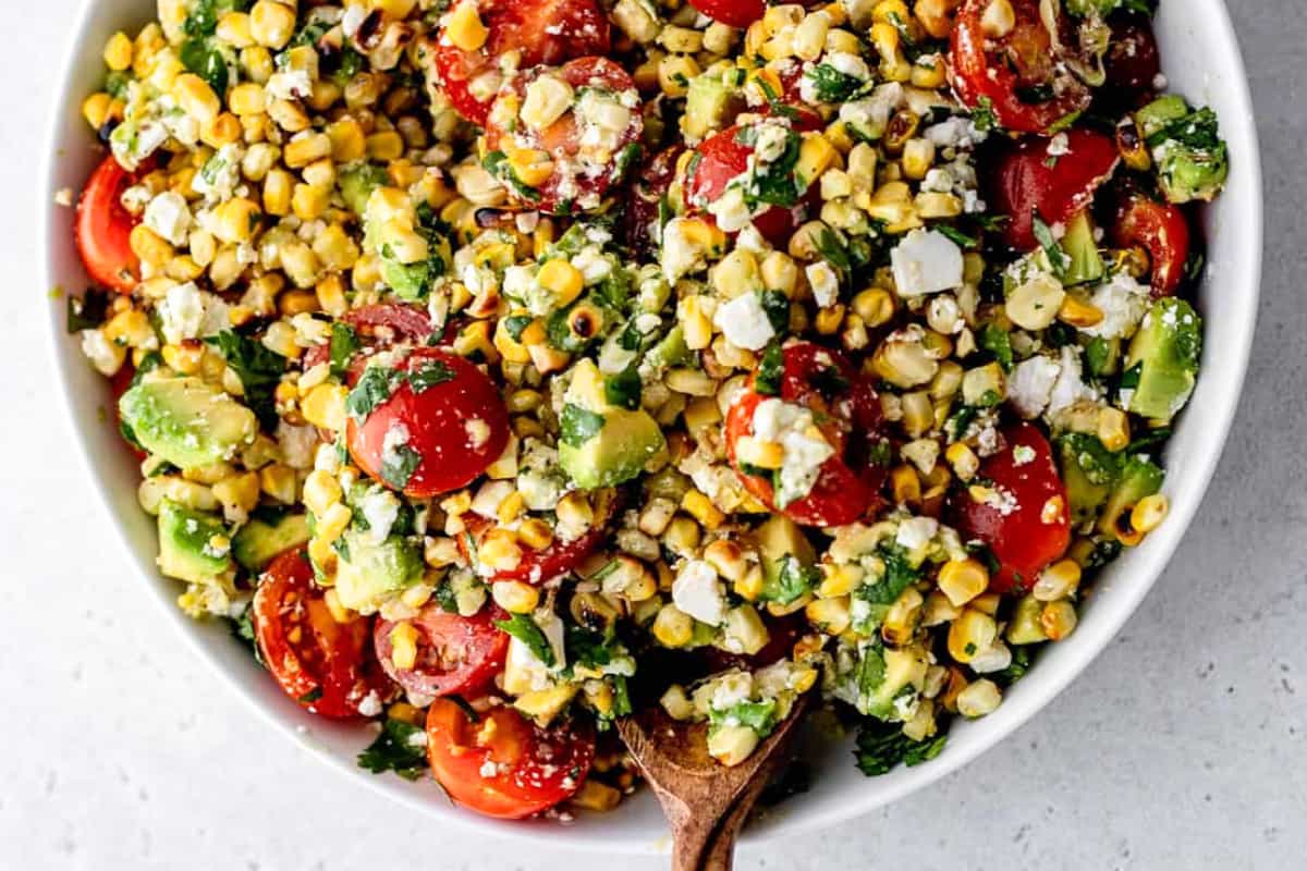 A bowl of Grilled Corn Avocado Salad.