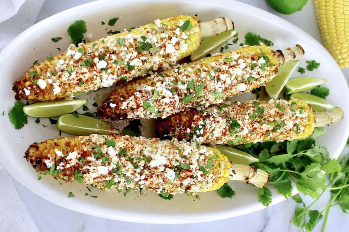 A plate of Mexican Street Corn on the cob.