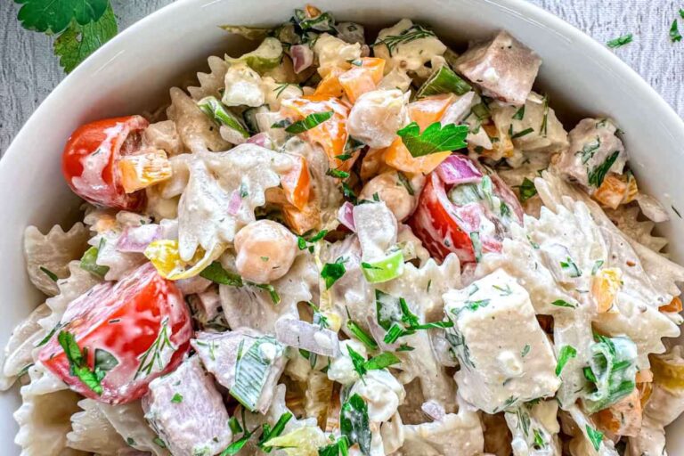 A dish of pasta salad with ham.