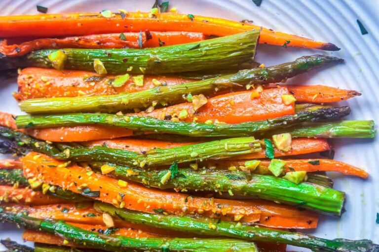 A plate of Roasted Carrots and Asparagus with Tarragon Butter.