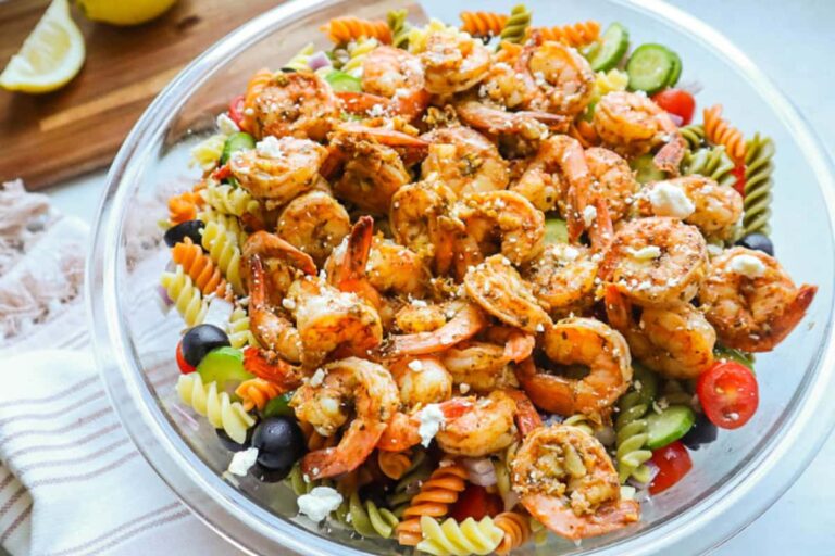 A bowl of shrimp pesto pasta salad.