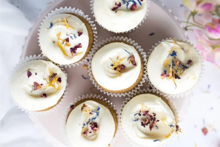 A plate of Honey Lemon Cupcakes with Cream Cheese Frosting.