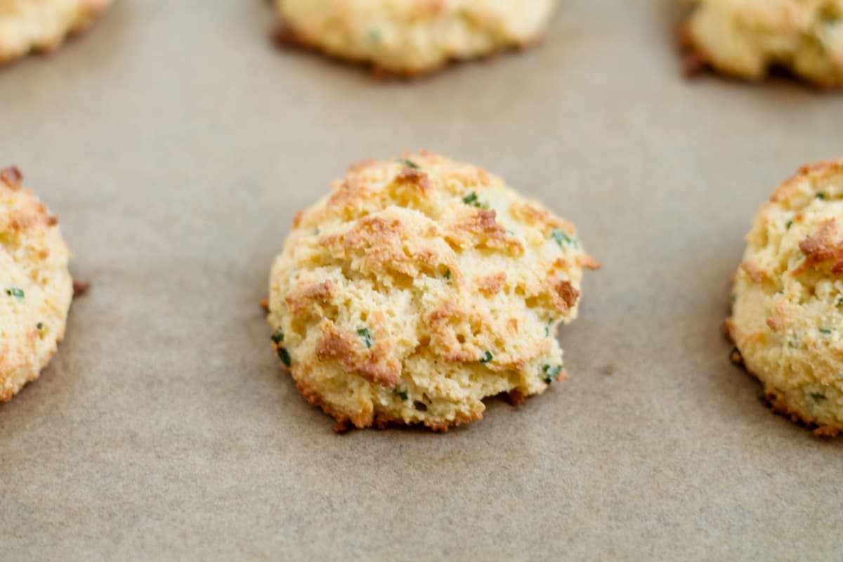 A freshly baked biscuit on a baking sheet.