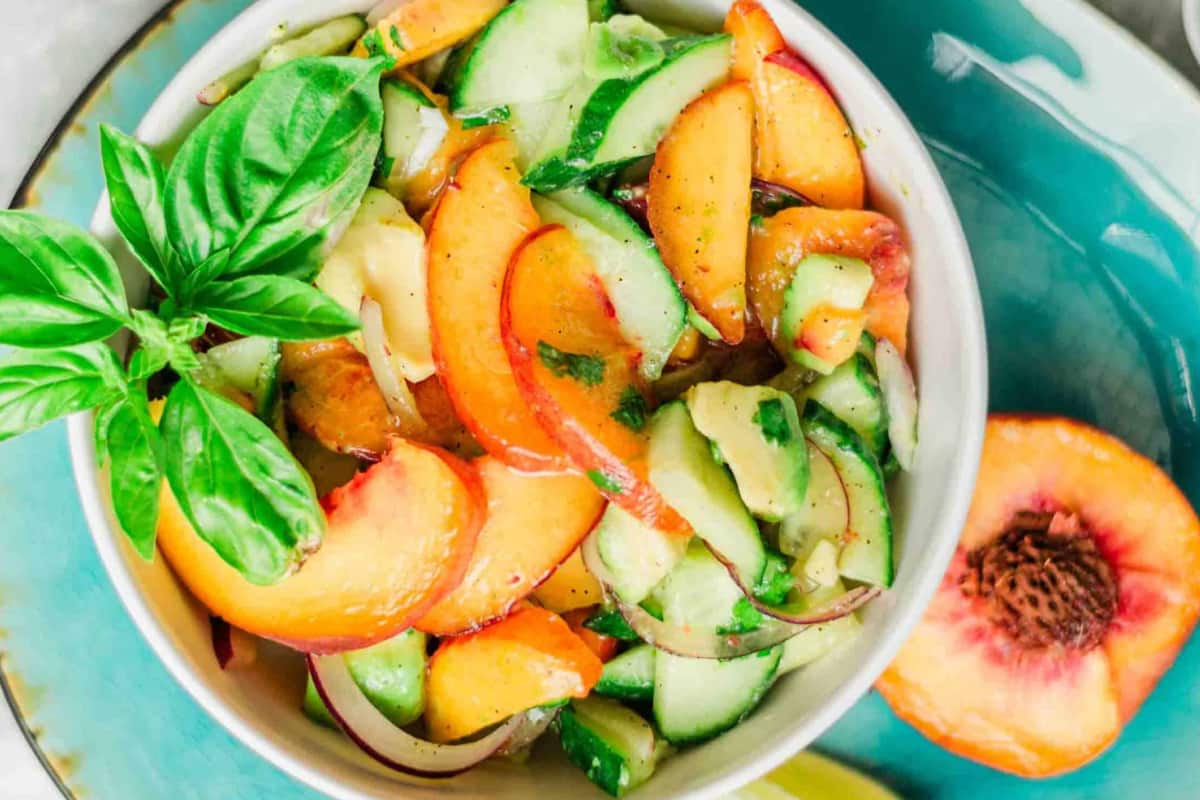 A bowl of Peach Avocado Salad with Honey-Lime Dressing.
