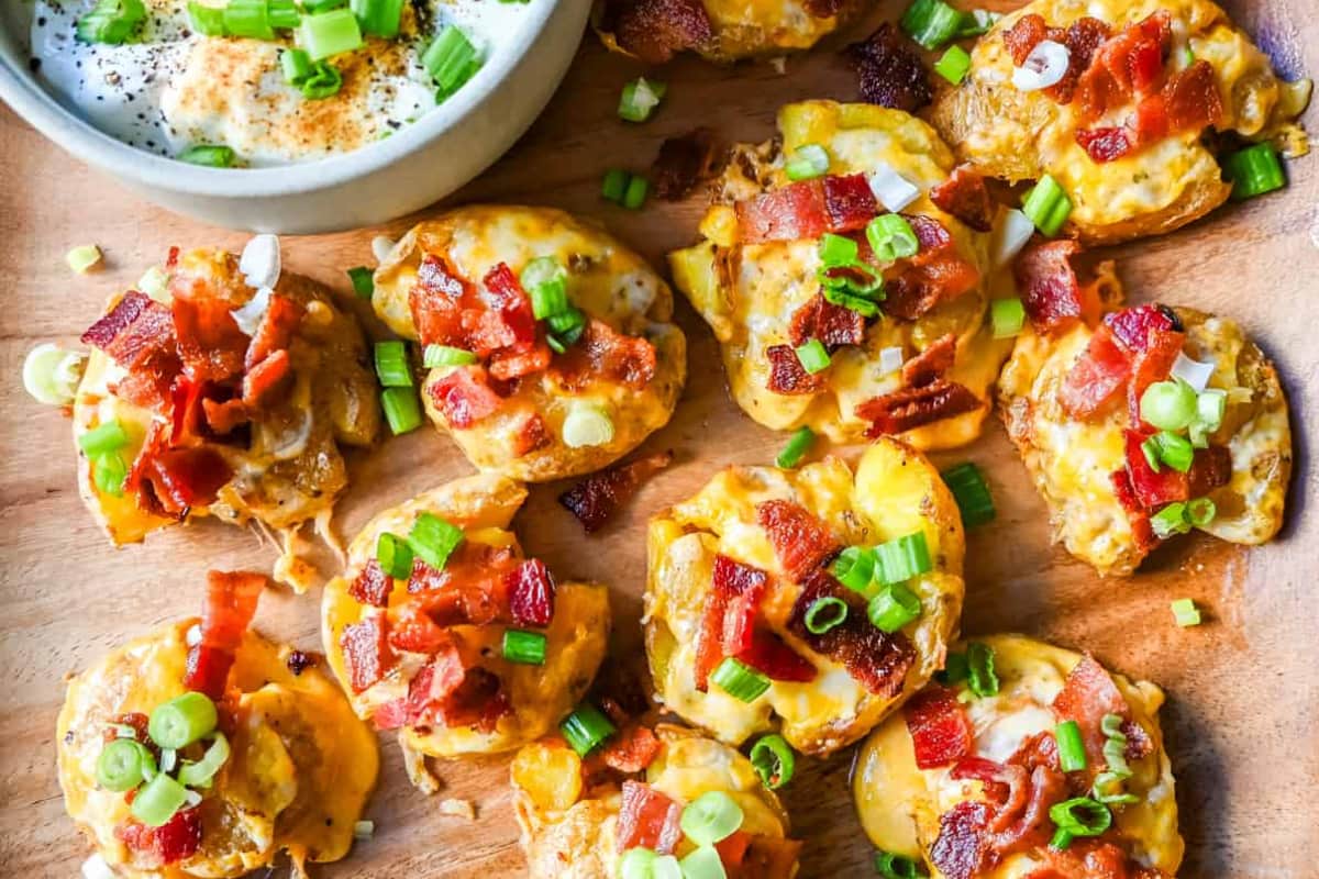 A plate of Loaded Bacon Cheddar Smashed Potatoes.