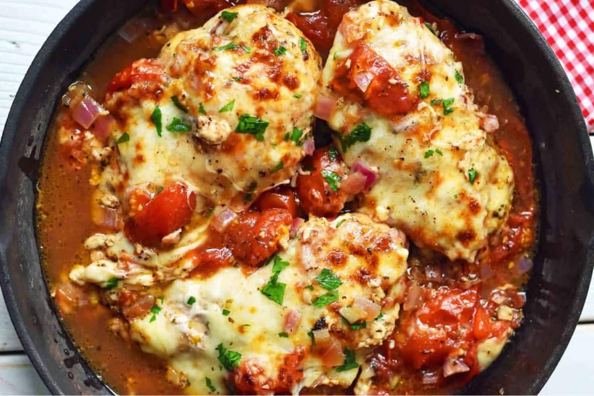 A skillet of Baked Caprese Chicken.