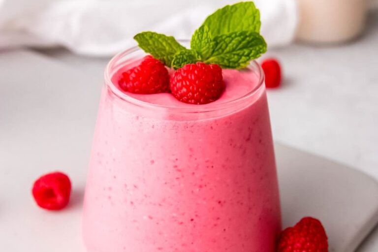 A glass of Creamy Raspberry Smoothie Recipe (Without Banana).