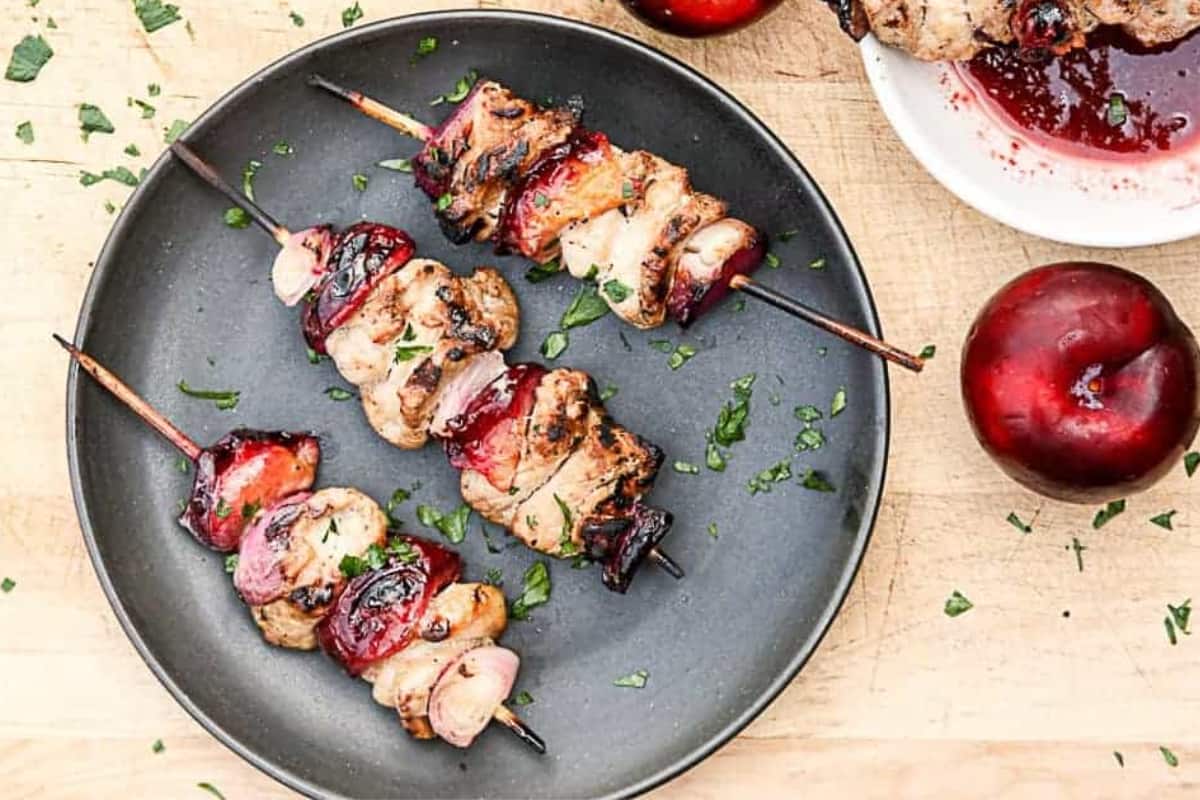 A plate of Grilled Plum and Pork Kebabs.