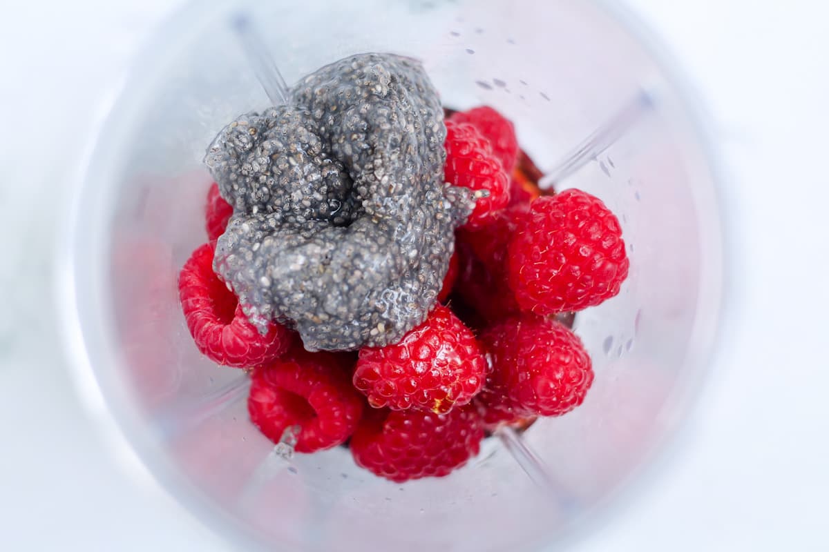 A blender with ingredients in it.