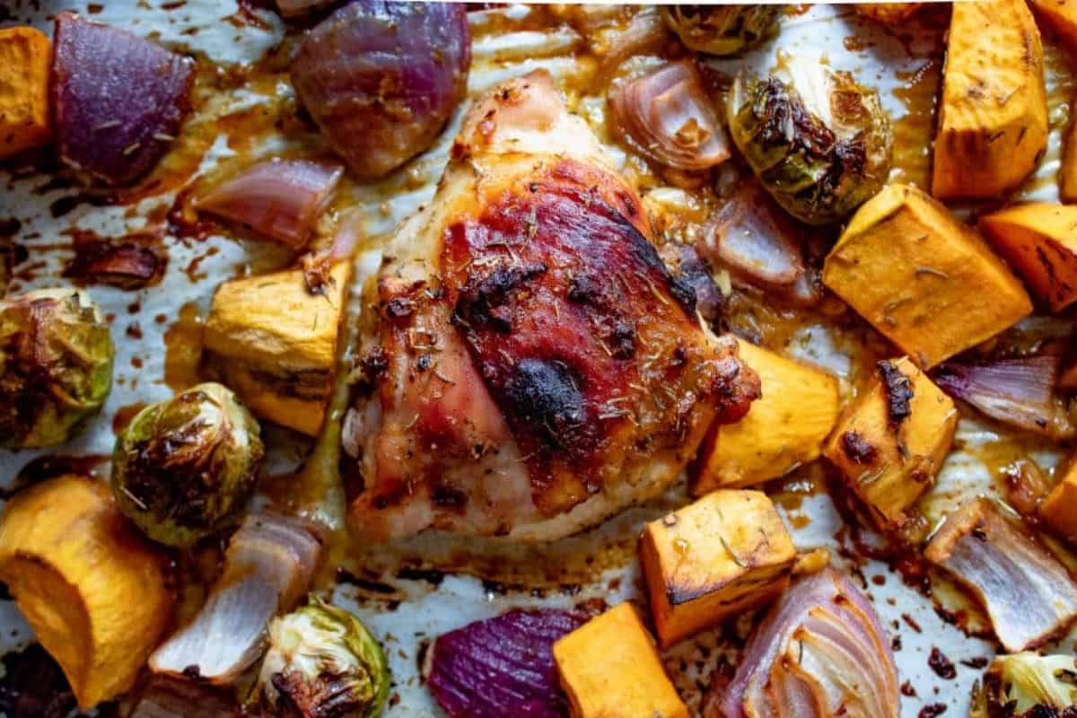 A dish of Sheet Pan Chicken Thighs and Veggies.