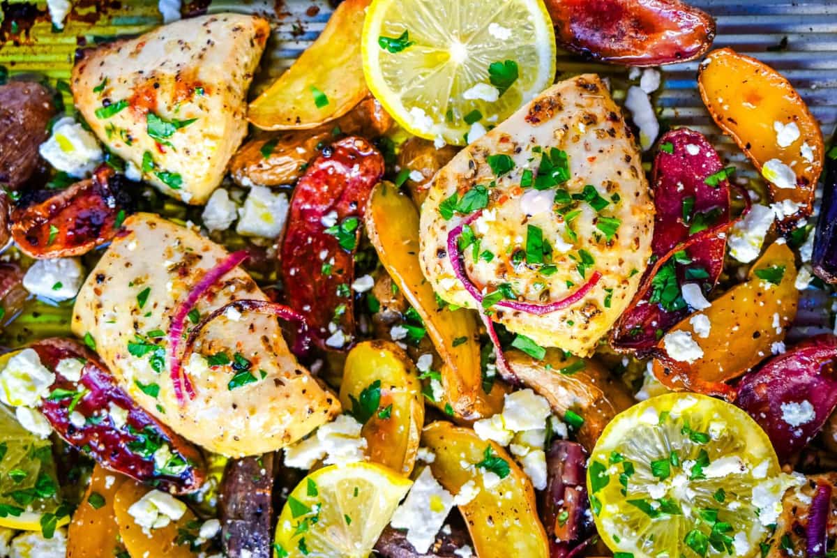 A dish of Sheet Pan Greek Chicken and Potatoes.