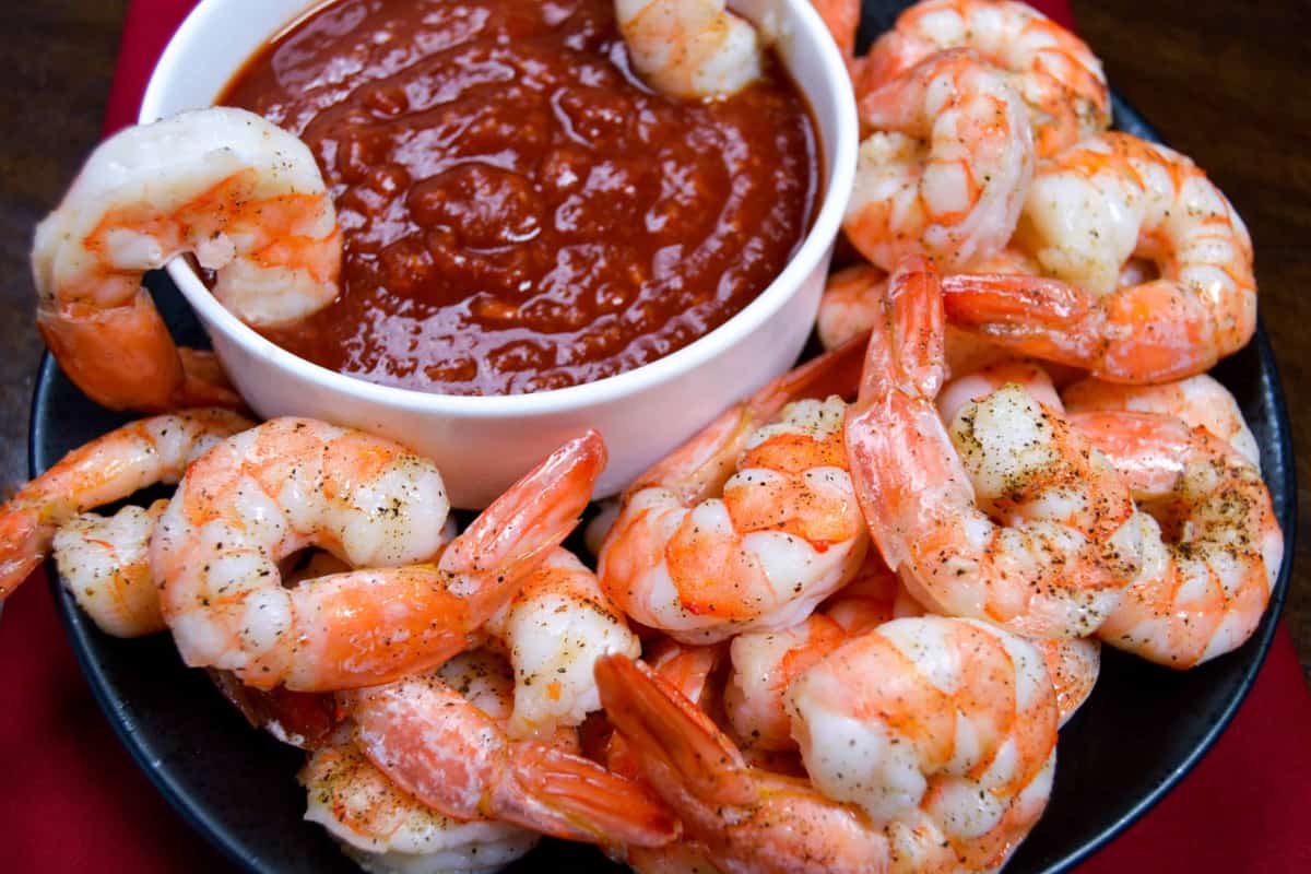 A plate of Roasted Shrimp Cocktail with Quick Cocktail Sauce.
