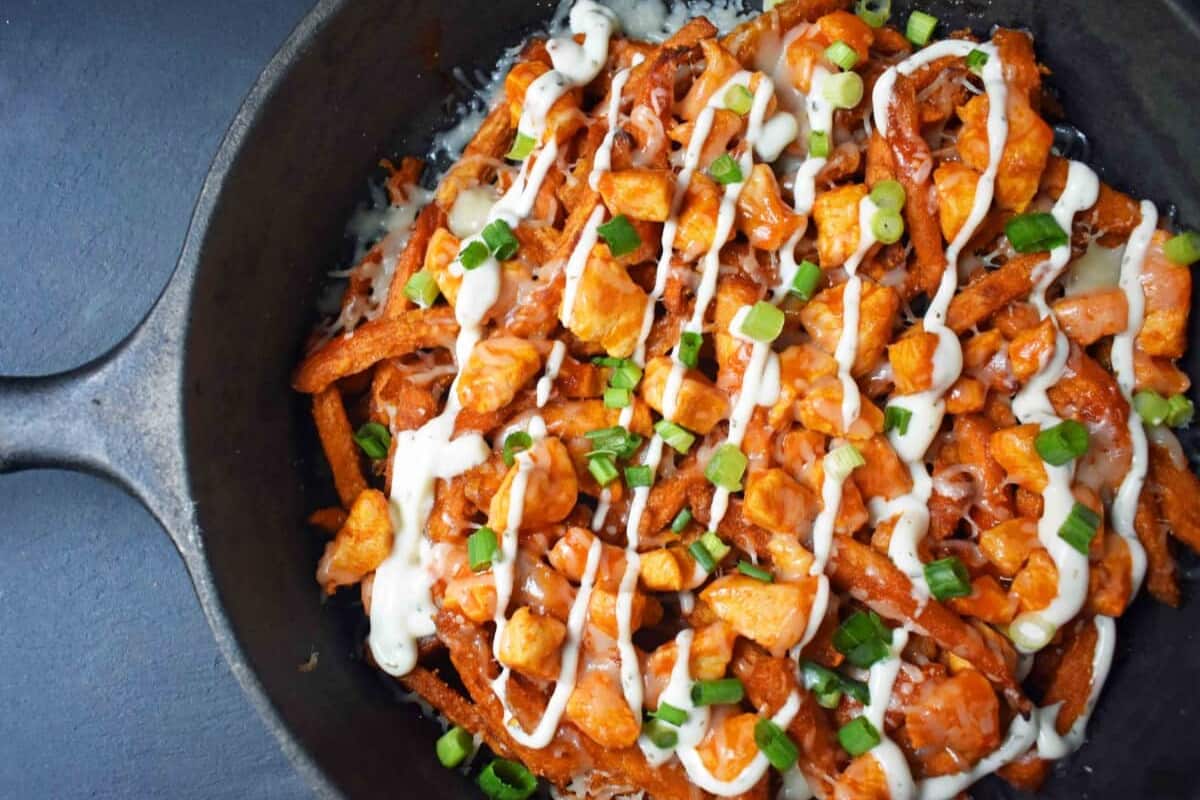 A dish of Buffalo Chicken Sweet Potato Fries.