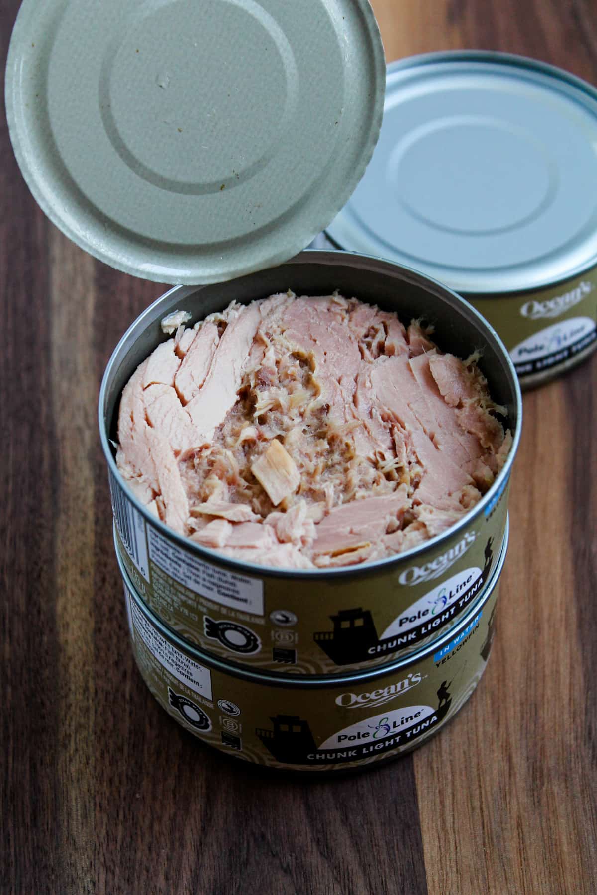 Cans of tuna on a counter.