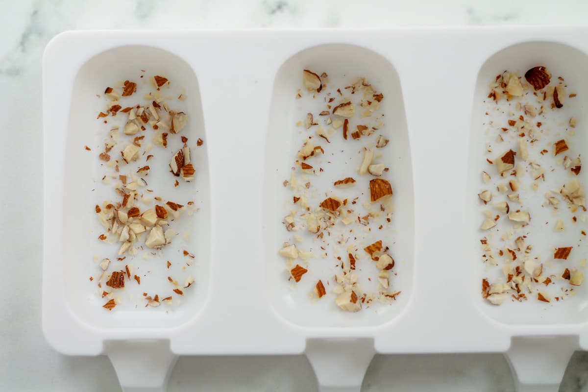 Chopped almonds inside a silicone mold.