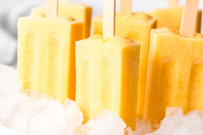 A dish of Creamy Homemade Mango Popsicles.