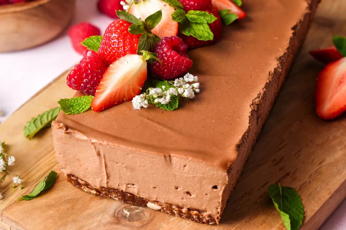 A plate of No-Bake Vegan Chocolate Strawberry Cheesecake.