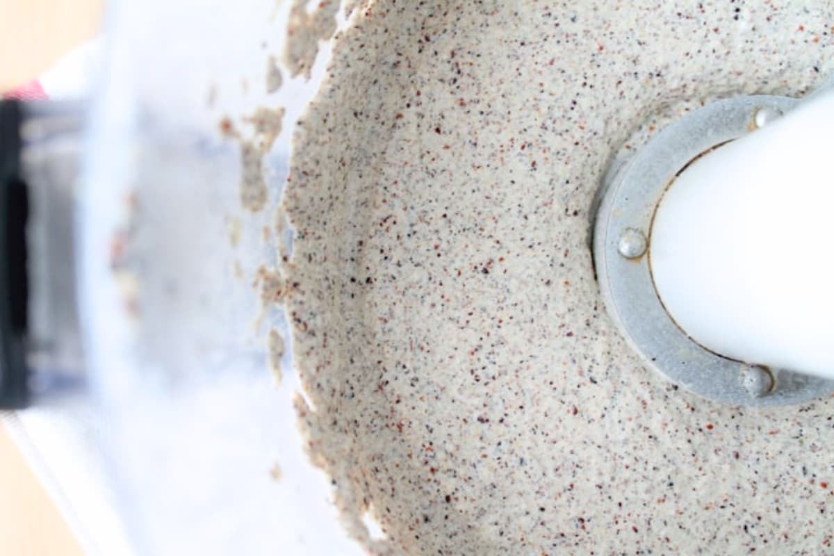 A food processor with ingredients being mixed.