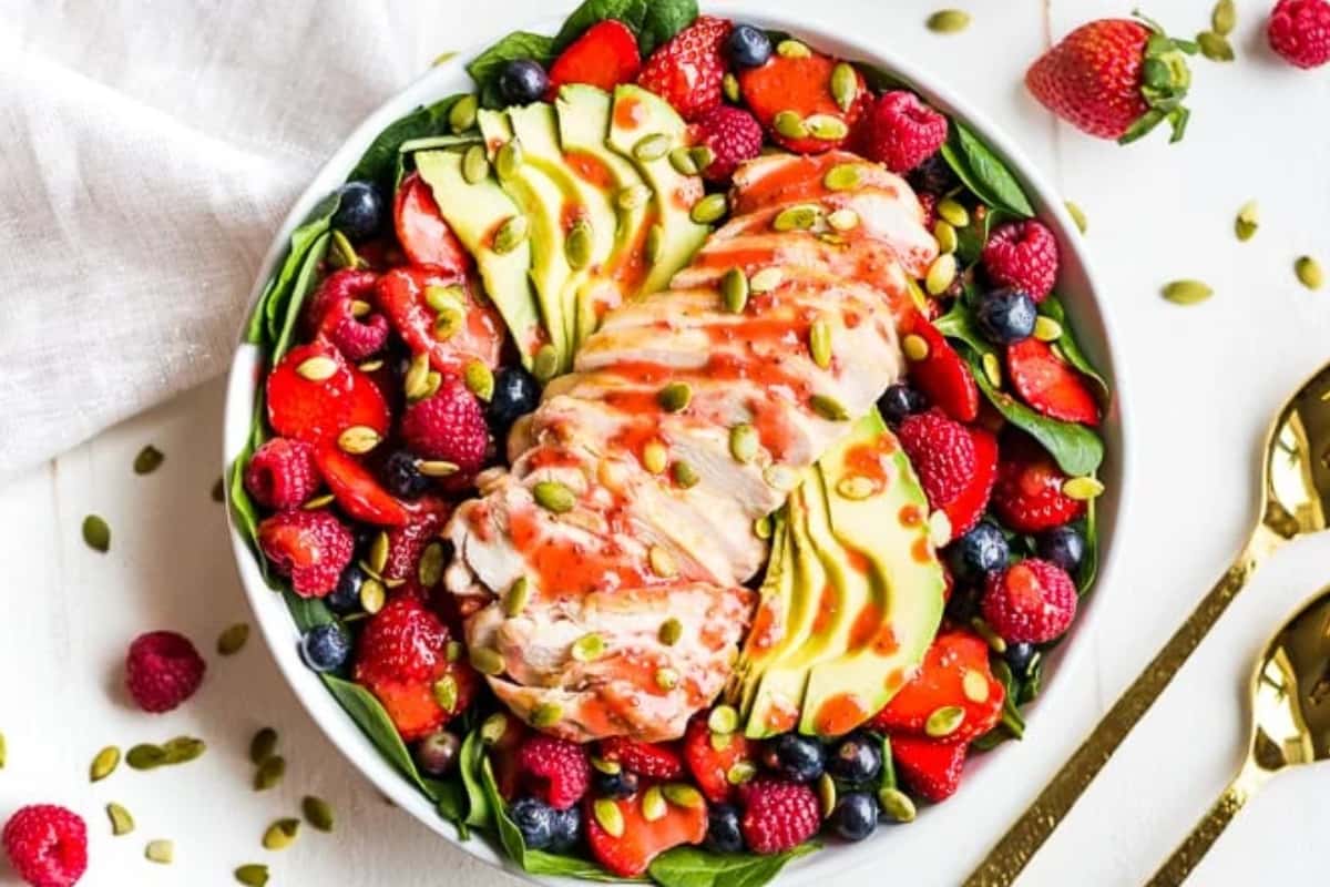 A bowl of Spinach Berry Chicken Salad.