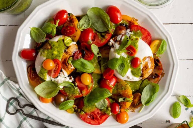 A plate of Burrata Caprese Salad with Fresh Basil Vinaigrette.